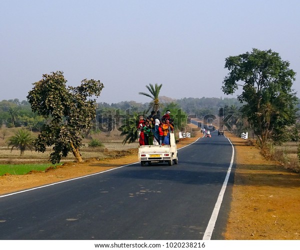 Purulia, West Bengal / India - 24th January 2018\
: Over crowded overloaded cars and vans packed up with village\
people enjoying their risky journey to Makri Mela fair at Budhpur\
Manbazar on highway