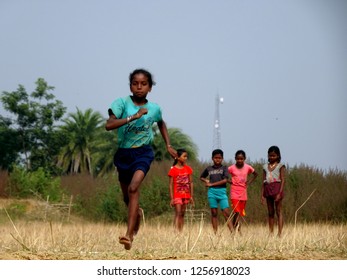 Purulia, West Bengal / India - 26th November 2018 : An Indian Tribal School Girl Running For A Long Jump With Some Others Waiting At A Field For Block Level Sports Competition At Manbazar 