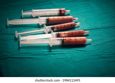 Pus From Brain Abscess In Syringes On The Green Table In Operating Room.