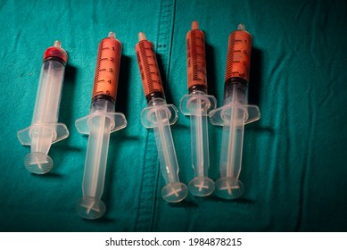 Pus From Brain Abscess In Syringes  On Green Table In Operating Room