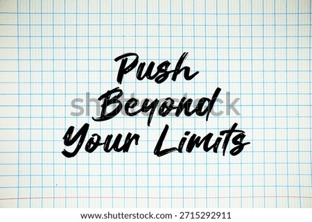 Push Beyond Your Limits text written on white notebook sheet with grid