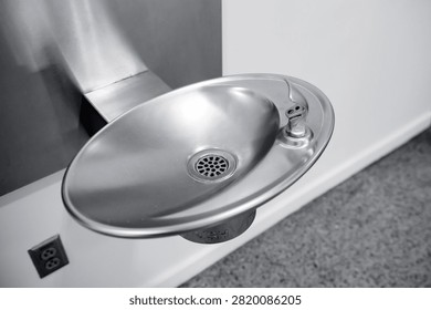 Push button brass bubbler wall mounted indoor drinking fountain.