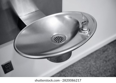 Push button brass bubbler wall mounted indoor drinking fountain.