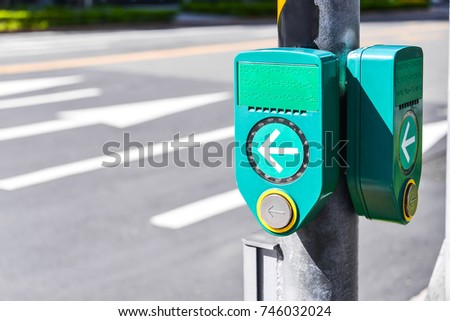 Push button to cross road with Braille code