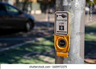 Push button cross walk intersection on a light post with sign