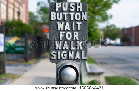 Push Button Wait For Walk Signal Sign at an Urban Street Crossing