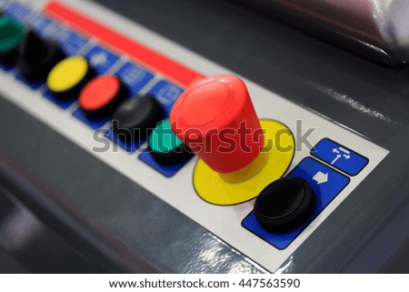 Push buttons on operation panel of industrial machinery.