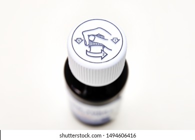Push down turn childproof cap on a medicine bottle with guided illustration on method to open the container cover, isolated on white background. Symbol on lid instructing users on how to open bottle.