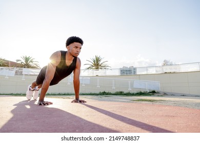 Push up exercise. Young guy doing push ups. Outdoor training and working out. Latin guy.
