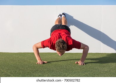 Push Up Fitness Man Training Using Wall Doing Decline Pushup At Outdoor Gym. Male Fitness Athlete Doing Advanced Push-ups On Grass Park.