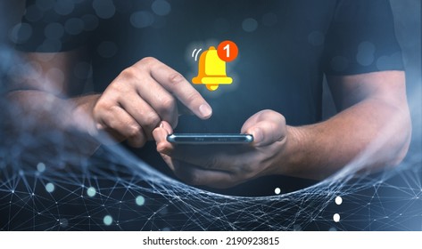push notification. smartphone with virtual yellow bell ringing for application notification alert concept. Man holding phone and touching with virtual bell for E-mail with notification alert - Powered by Shutterstock