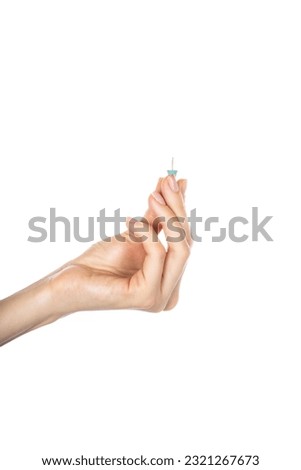Push pins in hand isolated on white background. High quality photo