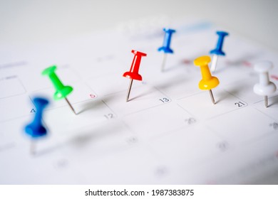 Push pins on calendar, mark the Event day with a red pin. Close-up of red pins. - Powered by Shutterstock