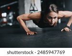 Push ups, girl and fitness in gym on ground for workout, health and wellness with power or resilience. Plank, athlete and training in sports club for exercise, competition and body goals with muscle