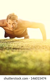 Push Ups Sport Fitness Man Doing Push-ups. Male Athlete Exercising Push Up Outside In Sunny Sunshine. Fit Shirtless Male Fitness Model In Crossfit Exercise Outdoors. Healthy Lifestyle Concept.