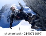 Push yourself to the top. Shot of a mountaineer hanging from a rope on a rockface.
