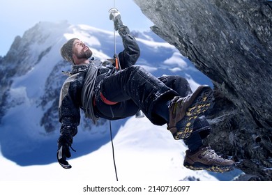 Push yourself to the top. Shot of a mountaineer hanging from a rope on a rockface.