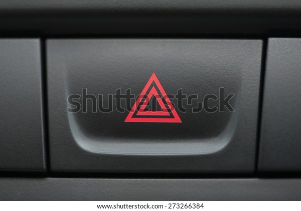 pushed red warning button with triangle
pictogram, close up view and flasher
light.
