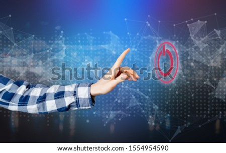pushing the power on button on the grunge surface, electricity supply