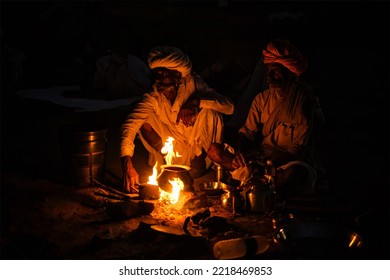 Pushkar, India - November 6, 2019: Indian Rural Village Men And Camels Lit By Camp Fire In Night At Pushkar Camel Fair Pushkar Mela - Annual Famous Camel And Livestock Fair And Tourist Attraction