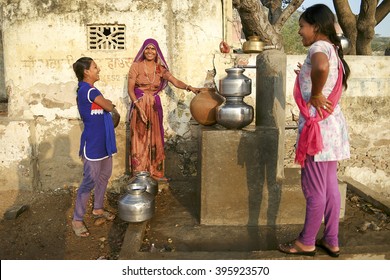  Pushkar, India-November 23, 2015:Unidentified Local Indian Women Pose For Camera In Water Collecting Center. Many Parts Of Urban India Are Experiencing Acute Water Shortage As Cities Expand Rapidly.