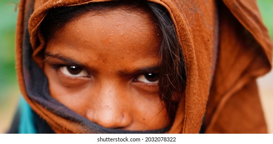 Pushkar, Rajasthan India August 19 2021: Very Closeup forehead of slum girl while face is covered with cloth selective focus