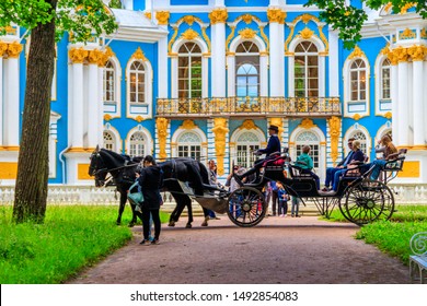 Pushkin, Russia - June 28, 2019: Tourists ride a horse-drawn carriage in Catherine park at Tsarskoe Selo in Pushkin, Russia