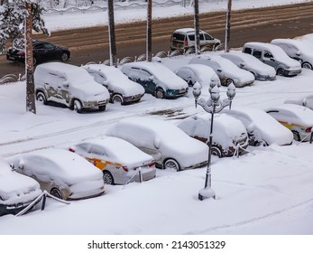 Pushkino, Russia, April 3, 2022. View Of The Street And Parking Covered By An Unexpected Snowfall. Weather Anomaly.