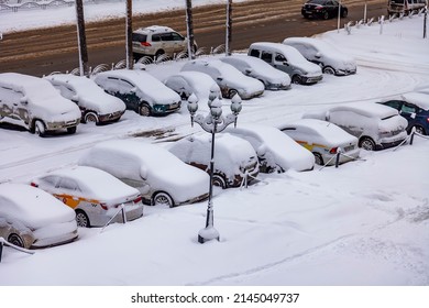 Pushkino, Russia, April 3, 2022. View Of The Street And Parking Covered By An Unexpected Snowfall. Weather Anomaly.