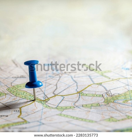Pushpin marking the location of a destination point on a roadmap map background with copy space