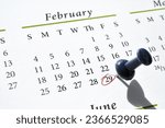 A pushpin and red circle in ink marking Leap Year Day, February 29, on a calendar