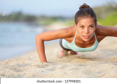 Push-ups Fitness Woman Doing Pushups Outside On Beach. Fit Female Sport Model Girl Training Crossfit Outdoors. Mixed Race Asian Caucasian Athlete In Her 20s.