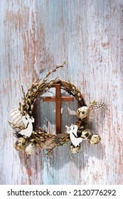 Pussy Willow Wreath, Eggs, Cross And Decorative Angels On Rustic Wooden Background. Easter, Palm Sunday Holiday. Prayer, Faith, Spiritual Life, Orthodox Church, Religion Concept. Flat Lay