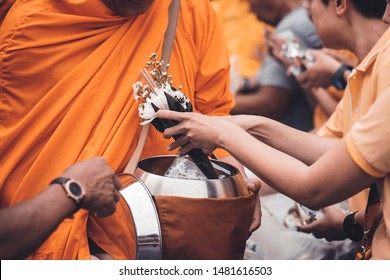 Put Alms To Make Merit In Buddhism