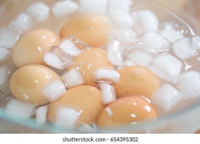 Put boiled eggs in ice water.