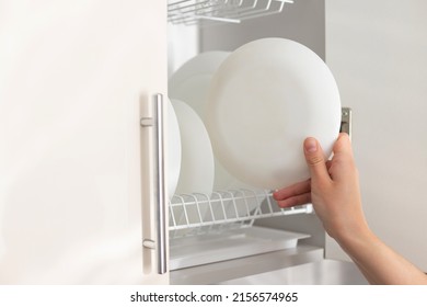 Put A Clean Plate On A Shelf In The Kitchen. Close-up