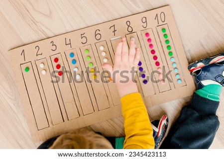 Put correct strap with balls of cotton wool to assigned cavity with number. Preschool educational aid for kindergartens. children early learning Montessori kit for intelligence.