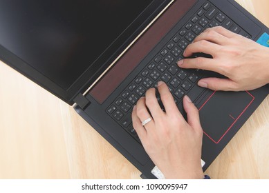 Put hand for type text on black laptop 