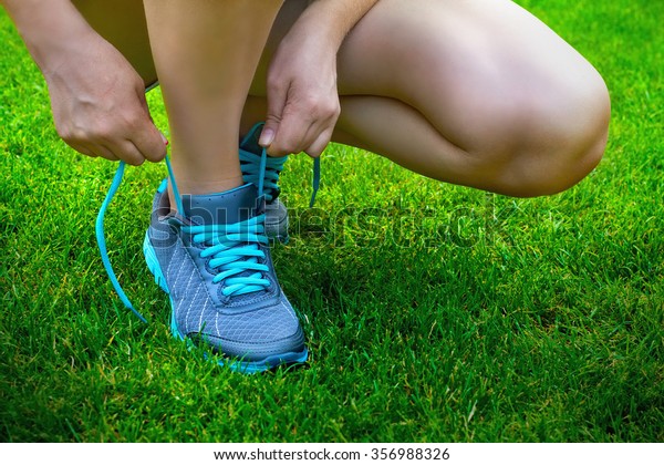 put on running shoes on the green grass, sport,\
athletic shoes, running