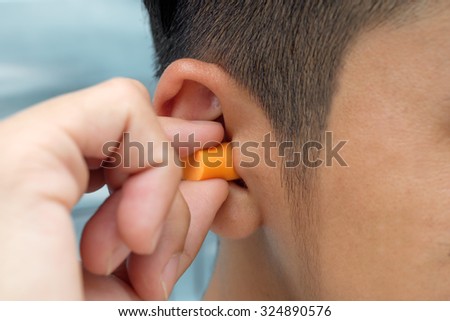 Put protective earplug into the ear