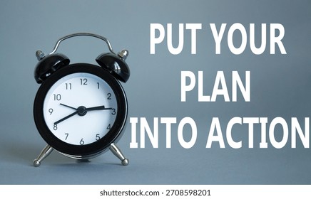Put your plan into action symbol. Concept words Put your plan into action on white puzzle. Beautiful grey background with alarm clock. Business concept and Put your plan into action. Copy space.