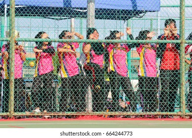 Putatan Sabah Malaysia - August 14, 2017: A Group Of Form Six Students From Penampang School Standing Outside A Netball Court Watching Their Friends Playing Under The Hot Sun. 