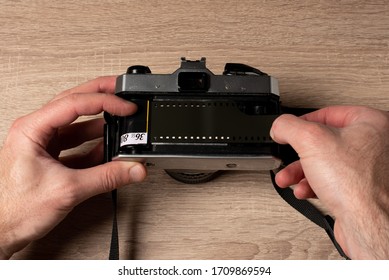 Puting a negative roll in an analog retro camera.