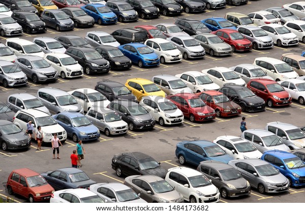 PUTRAJAYA, MALAYSIA\
- AUGUST 12, 2019 : Aerial view of vehicles parked in a outdoor car\
park near shopping\
mall.