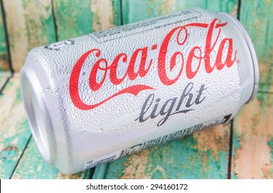 PUTRAJAYA, MALAYSIA - JULY 5TH, 2015. Coca Cola Light on weathered wood. Coca Cola drinks are produced and manufactured by The Coca-Cola Company, an American multinational beverage corporation.