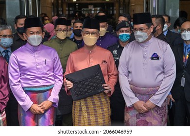 Putrajaya, Malaysia - October 29, 2021:  Finance Minister Tengku Zafrul Aziz (C) holds a briefcase containing the 2022 budget speech outside the Finance Ministry building. 