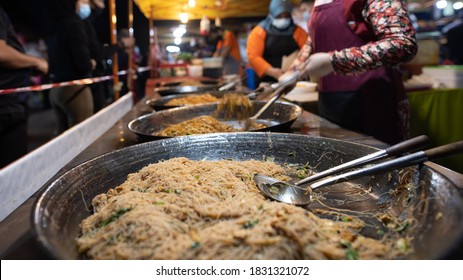 Putrajaya, Malaysia - October 9, 2020: Street food night market at  Putrajaya, near Kuala Lumpur. A fried noodles store in the fresh market Putrajaya. Barrier tape next to it ensures social distance