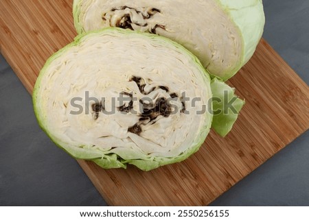 Putrid white cabbage. Vegetable looks normal from the outside, but rotten inside. Rotten cabbage head. Expired food. Concept - Improper storage of vegetables.