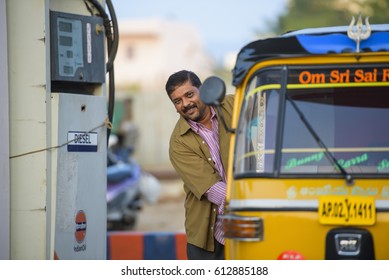 PUTTAPARTHI, ANDHRA PRADESH/INDIA - November 06 /2016: Indian Driver Of Local Taxi Stay And Smiling Next Petrol Station.