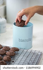  Putting biscuits in a tin.